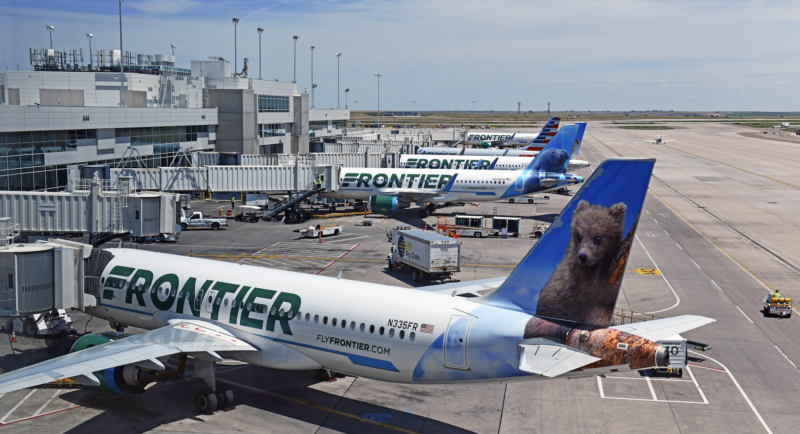 Frontier Airlines parked at a gate.